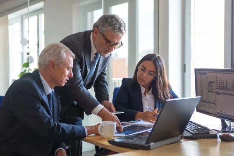 Concentrated Colleagues Watching Statistic Charts Talking About Work Professional Senior Managers Young Assistant Preparing Business Plan Teamwork Management Partnership Concept