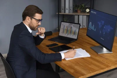 Person Looking Finance Graphs